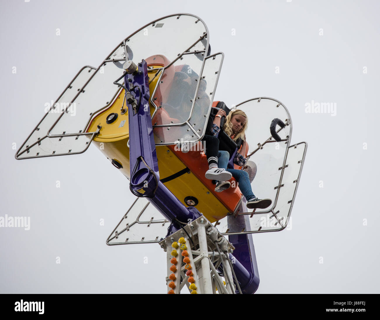 Children having fun on a ride at the county fair Stock Photo - Alamy