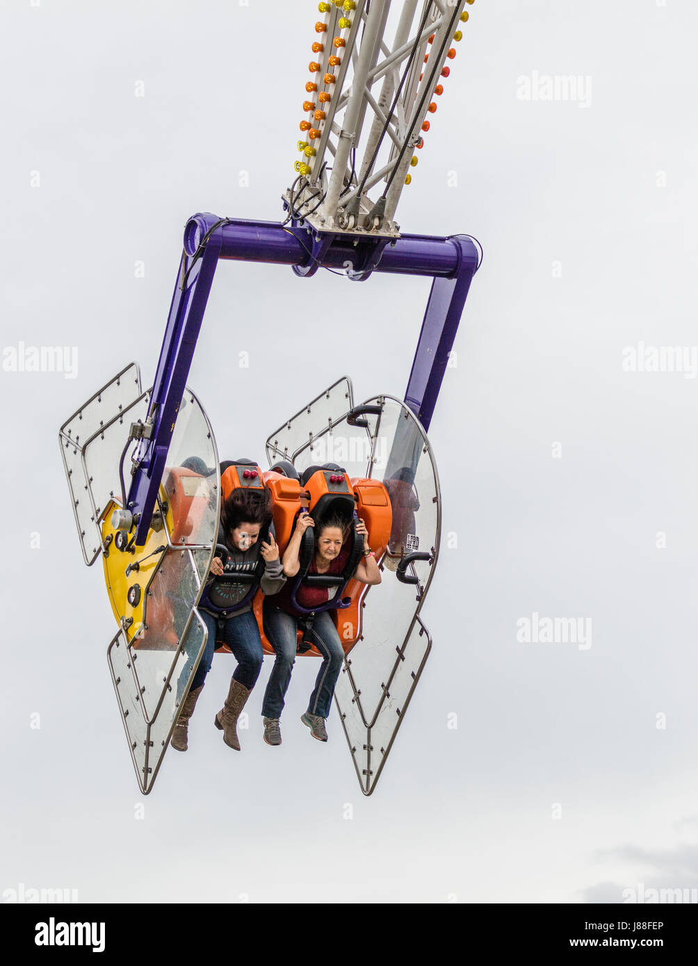 Children having fun on a ride at the county fair Stock Photo - Alamy