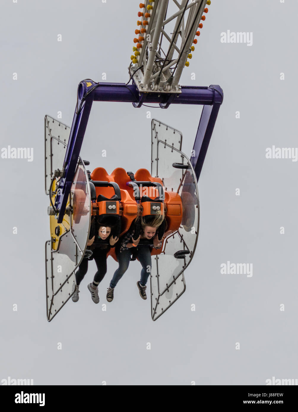 Children having fun on a ride at the county fair Stock Photo - Alamy