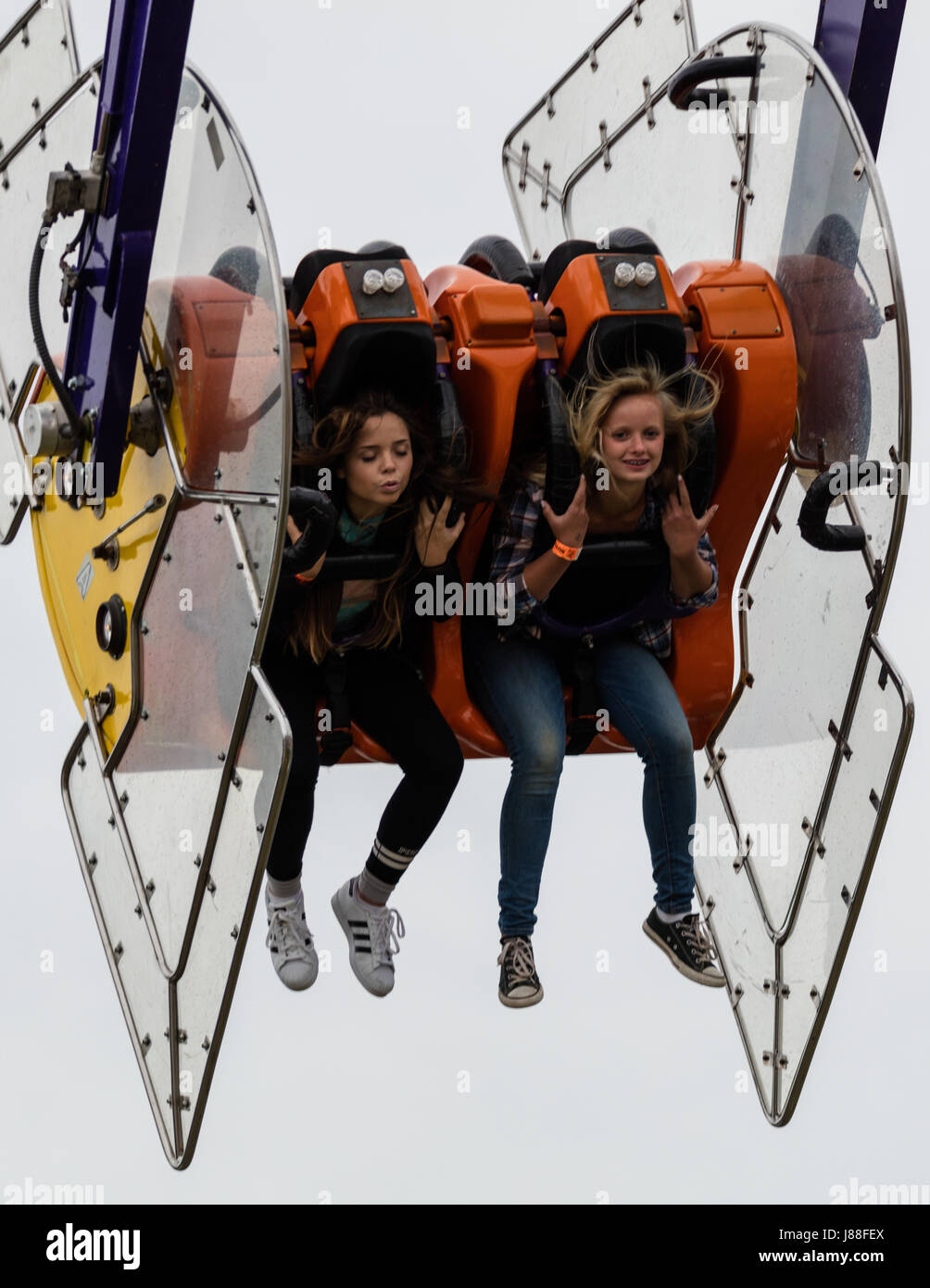 Children having fun on a ride at the county fair Stock Photo - Alamy
