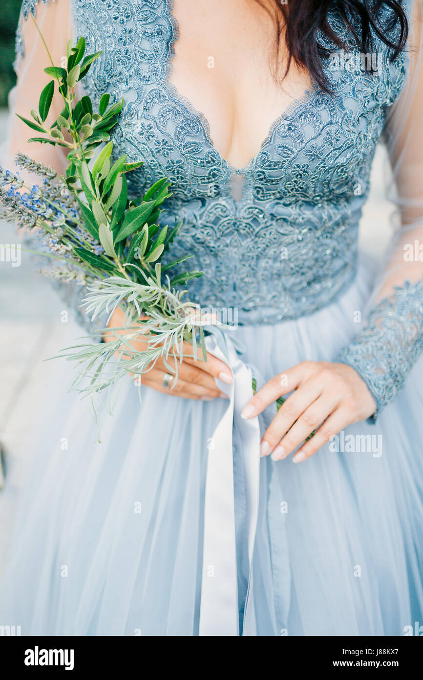 Lavender Wedding Bouquet In Hands Of The Bride In White Blue Dress