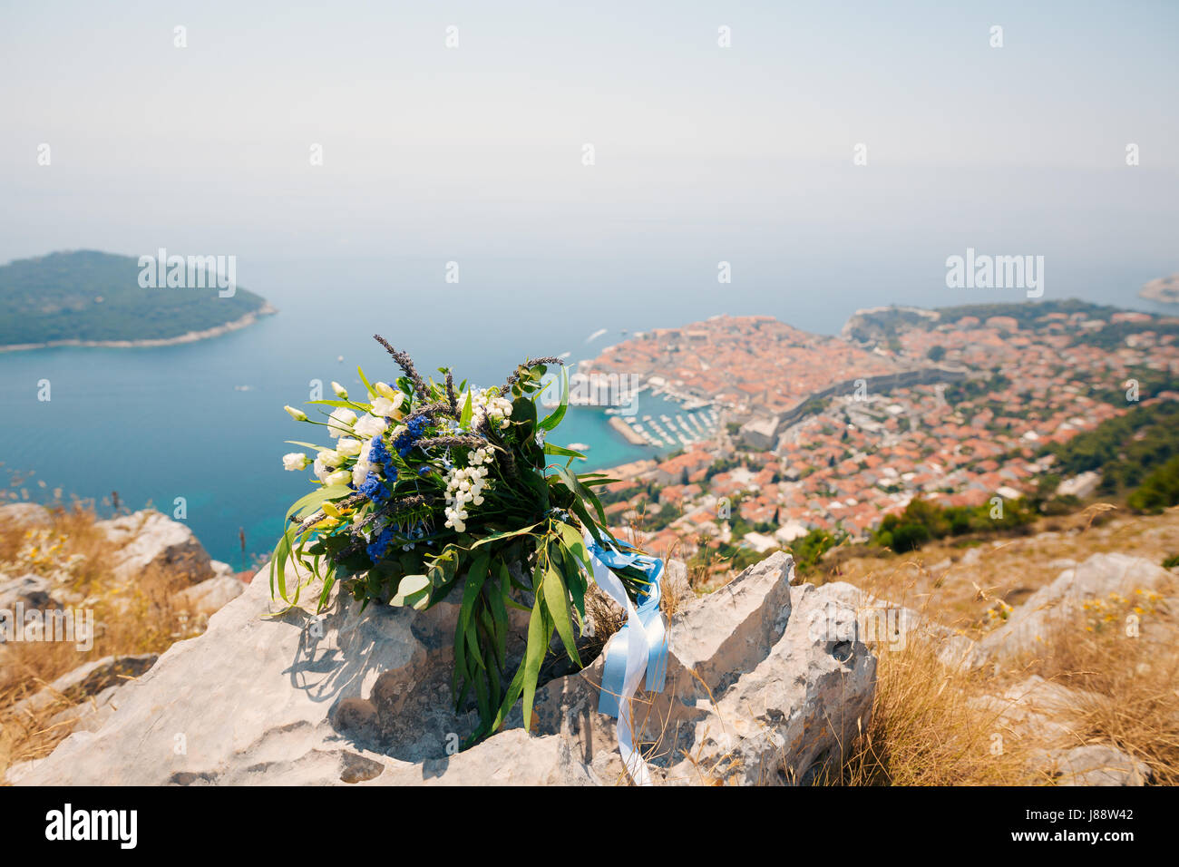 Wedding bridal bouquet of roses, lisianthus, lavender, Gypsophila, Verdure Italian on the stone with the background of Dubrovnik, the view from the ob Stock Photo