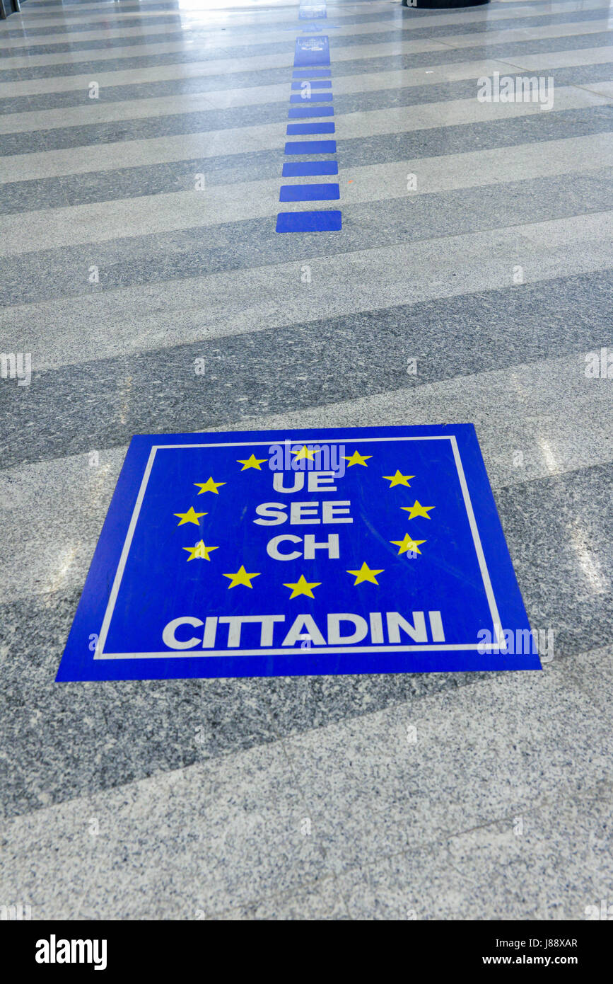 Immigration signs on floor at Milan's Malpensa Airport, Italy Stock Photo