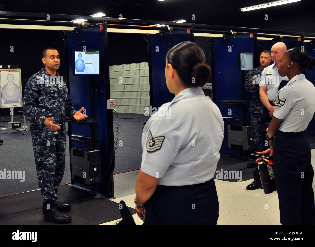170317-N-ZF693-033  GREAT LAKES Ill. (May 17,2017) Fire Controlman 1st Class Brandon Graham disscusses the weapon training of Navy recruits to members of the 2017 Drill Instructor Summit at the USS Missouri small arms marksmanship trainer onboard Recruit Training Command (RTC). Drill Instructors from each branch of the military gathered together during the summit to tour RTC, exchange ideas, and identify training practices to benefit enlisted personnel across the services. (U.S. Navy photo by Mass Communication Specialist 3rd Class Ivana Campbell/Released) Stock Photo