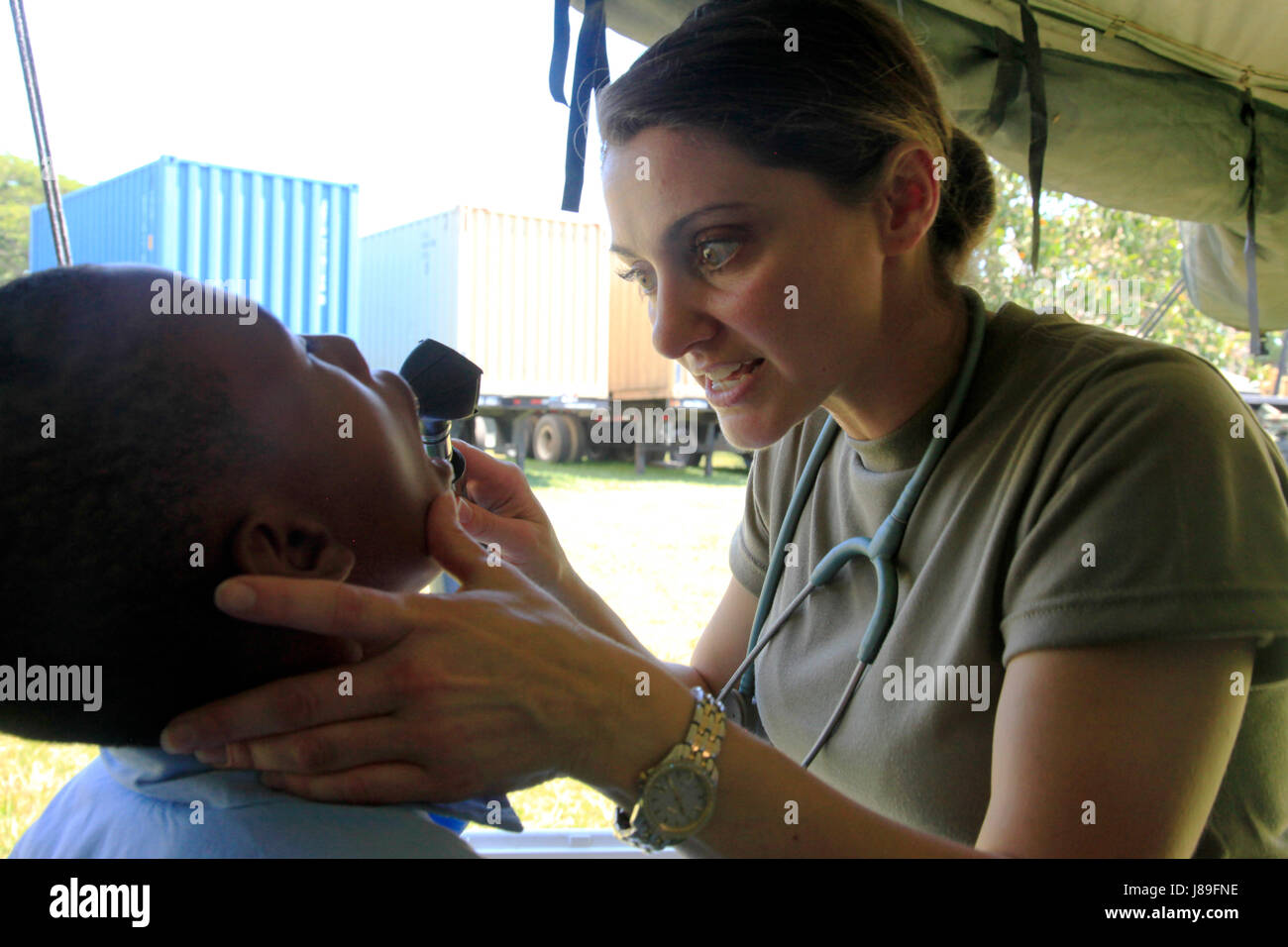 U.S. Army Capt. Ann-Marie Octavio, with the Wyoming National Guard Medical Detachment, observes the teeth of a patient from a nearby elementary school at a medical readiness event held during Beyond the Horizon 2017, in San Ignacio, Belize, May 15, 2017. BTH 2017 is a U.S. Southern Command-sponsored, Army South-led exercise designed to provide humanitarian and engineering services to communities in need, demonstrating U.S. support for Belize. (U.S. Army photo by Spc. Kelson Brooks) (RELEASED) Stock Photo