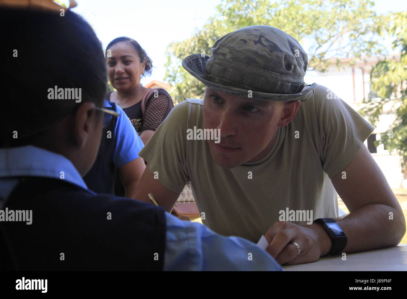 U.S. Army Spc. Kyle Grimshaw, with the 344th Psychological Operations Company (Airborne), based out of Austin, Texas, checks local students from a nearby elementary school into a medical readiness event during Beyond the Horizon 2017, in San Ignacio, Belize, May 15, 2017. BTH 2017 is a U.S. Southern Command-sponsored, Army South-led exercise designed to provide humanitarian and engineering services to communities in need, demonstrating U.S. support for Belize. (U.S. Army photo by Spc. Kelson Brooks) (RELEASED) Stock Photo