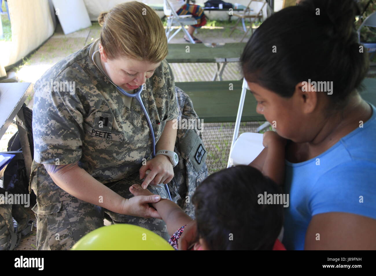 U.S. Army Capt. Stephanie Peete, with the Wyoming National Guard Medical Detachment, performs a check up on a patient at a medical readiness event during Beyond the Horizon 2017, in San Ignacio, Belize, May 15, 2017. BTH 2017 is a U.S. Southern Command-sponsored, Army South-led exercise designed to provide humanitarian and engineering services to communities in need, demonstrating U.S. support for Belize. (U.S. Army photo by Spc. Kelson Brooks) (RELEASED) Stock Photo