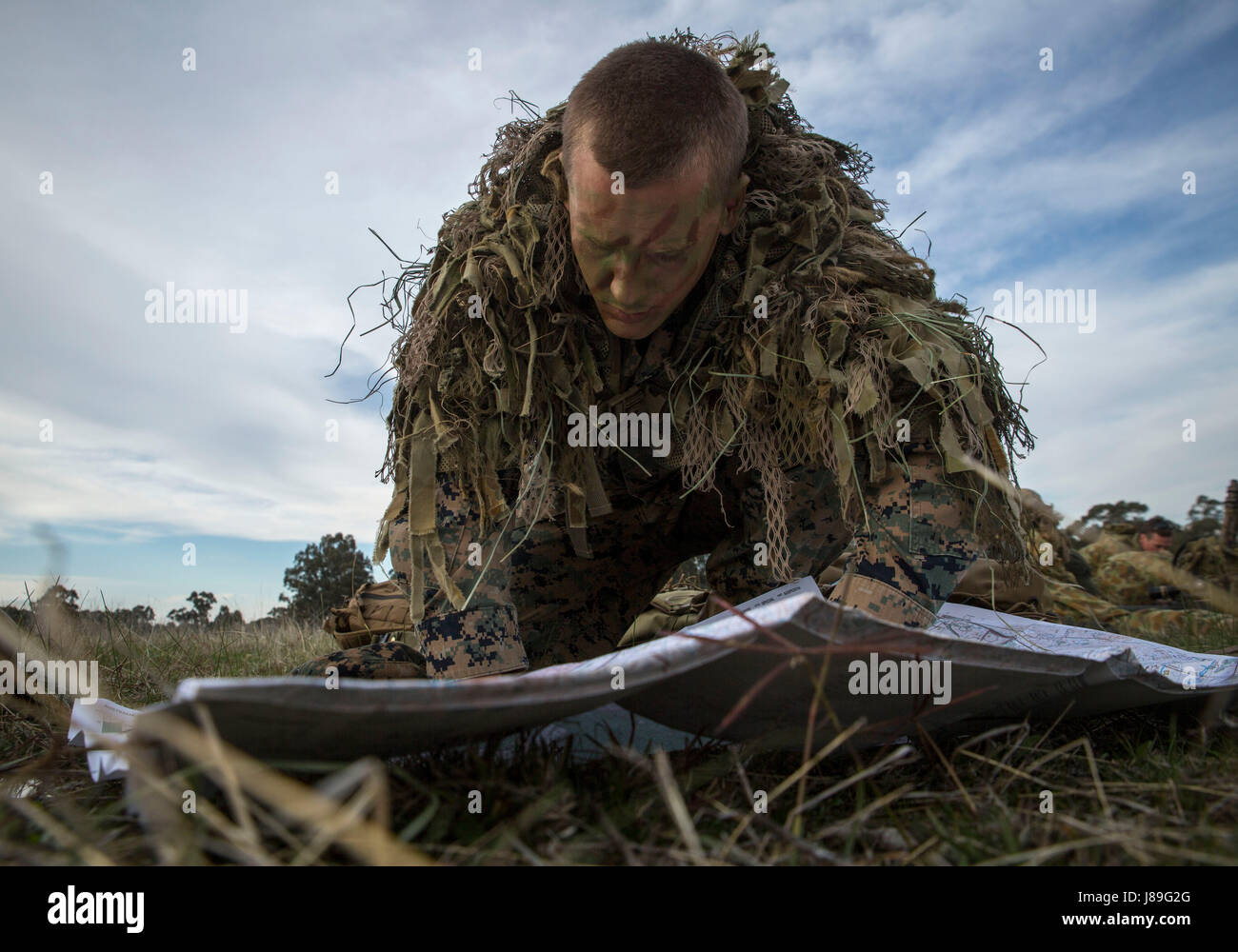 Sgt. Damian Knight checks his map, May 16, 2017, during a sniper competition at the Australian