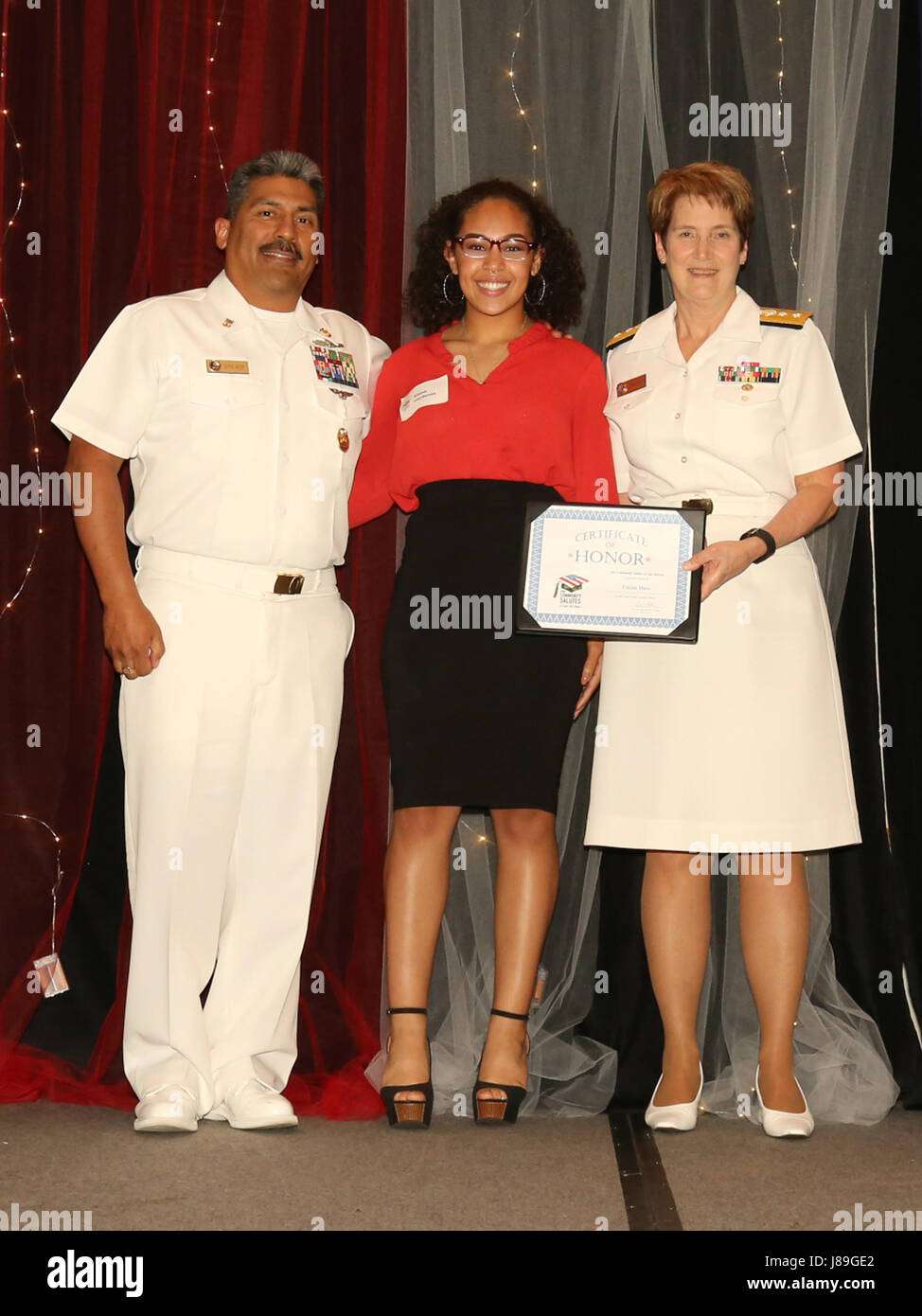 SAN ANTONIO – (May 17, 2017) Navy Rear Adm. Rebecca McCormick-Boyle, commander, Navy Medicine Education Training and Logistics Command, and Command Master Chief Mitchell Sepulveda Sr. pose with Kiana Cardena, a future Sailor, who was honored during Our Community Salutes-San Antonio’s 6th Annual “A Night in Your Honor” held in the Rosenberg Sky Room at the University of the Incarnate Word.  Each honoree received an Our Community Salutes certificate and challenge coin from USAA. (Courtesy Photo by Edward Jones, R40 Photos/Released) Stock Photo