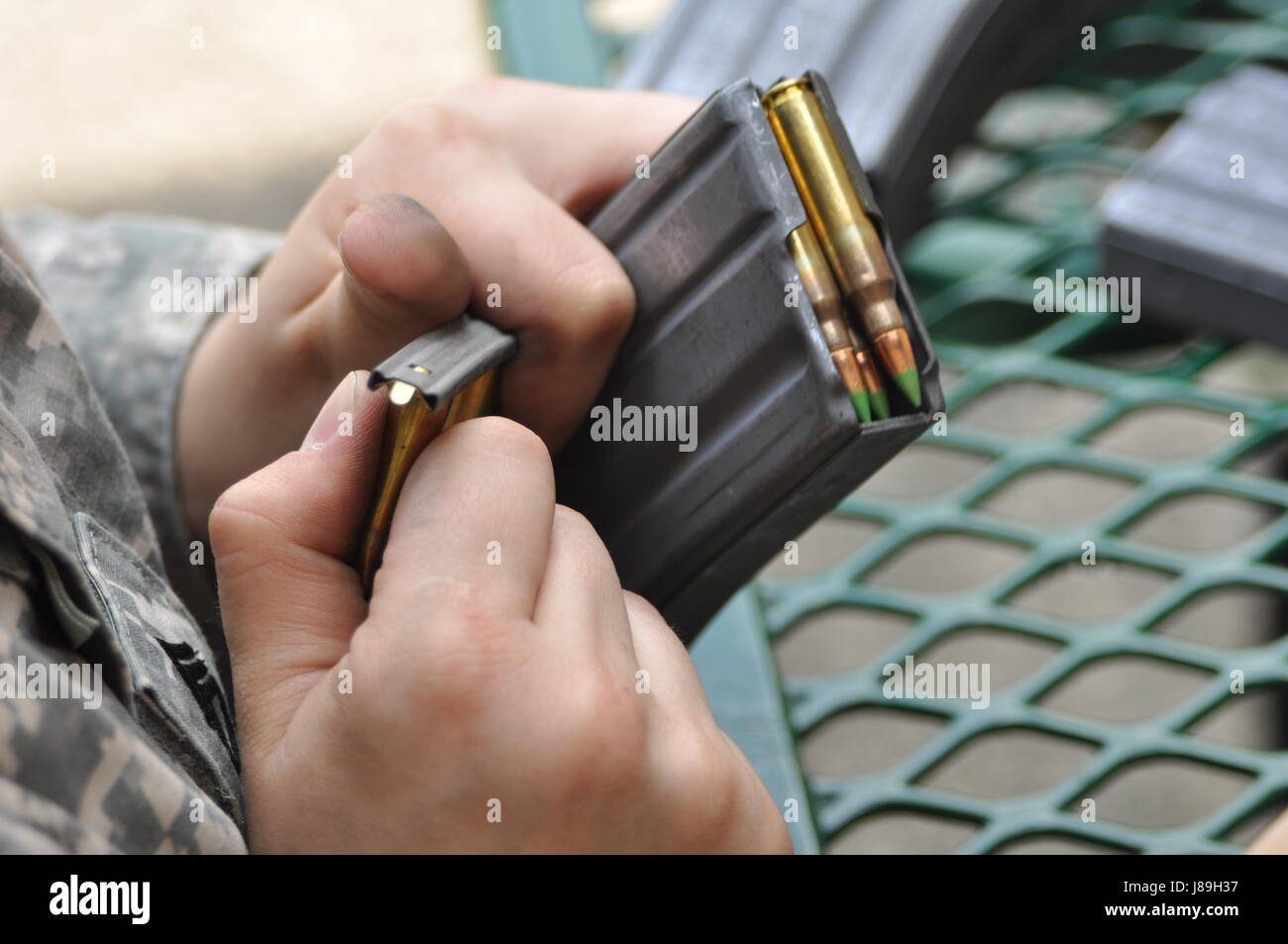 Guard Rounds Document A U.S. Army National Guard soldier loads 5.56mm rounds into an M4 ...