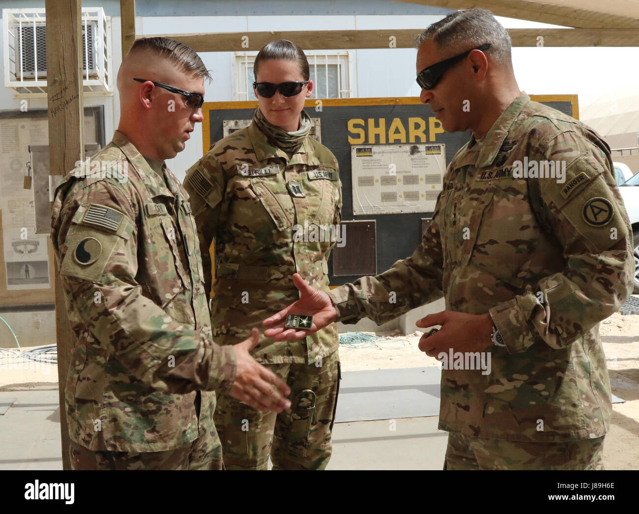 Lt. Gen. Michael Garrett, the commanding general for U.S. Army Central, presents coins to Soldiers with the 449 Aviation Support Battalion within the 29th Infantry Division, during a battlefield circulation at Camp Buehring, May 19. The tour provided Garrett the opportunity to see the proficiencies of his troops in theater. (U.S. Army photo by Sgt. Bethany Huff, USARCENT Public Affairs) Stock Photo