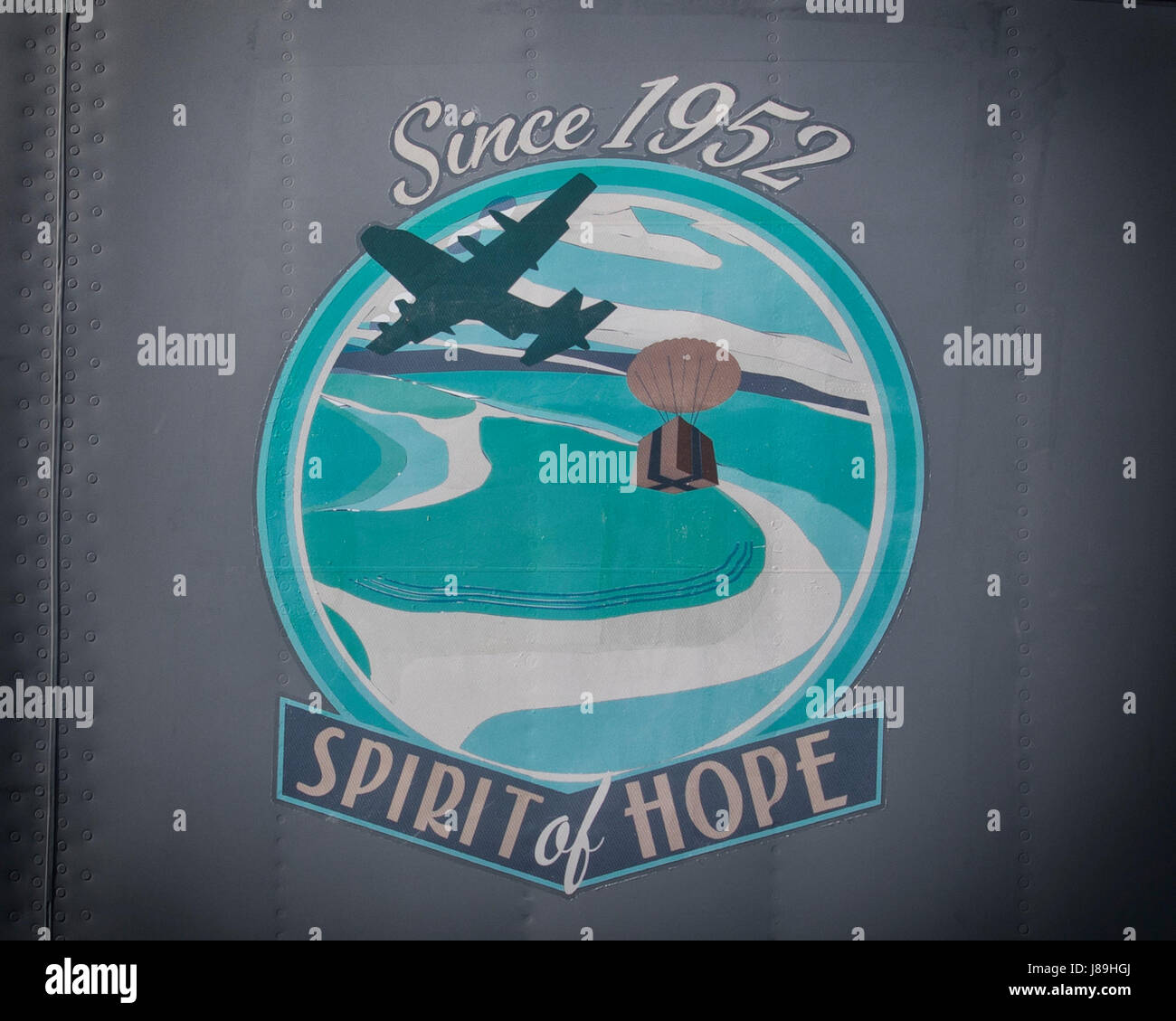 Nose art, “Spirit of Hope,” placed onto C-130J Super Hercules 15-5813 at Yokota Air Base, Japan, May 19, 2017. Yokota airmen and aircraft have been delivering humanitarian assistance and disaster relief operations since 1952, including Operation Christmas drop, Operation Unified Assistance in 2004 Indian ocean tsunami, Operation Caring Response in Myanmar following tropical cyclone Nargis, Operation Tomodachi in Japan, Operation Damayan in the Philippines following Typhoon Haiyan, and Operation Sahayogi Haat following the 2015 Nepal earthquake. The nose art depicts the world’s longest running  Stock Photo