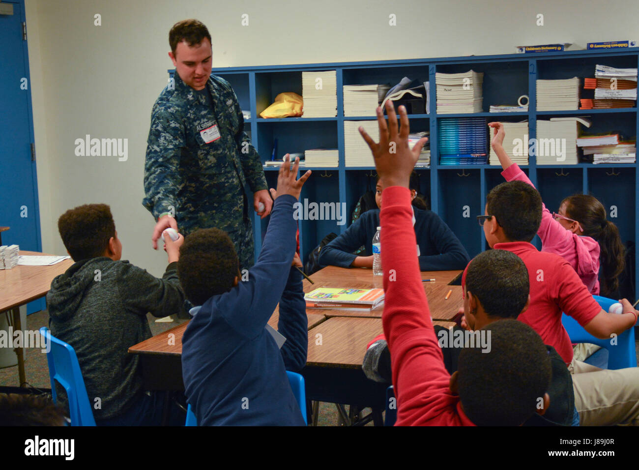 170519-N-IG780-048 IRVING, Texas (May 19, 2017) Machinist Mate 2nd Class Adam Al Sharif, a recruiter assigned to Navy Recruiting District (NRD) Dallas, answers questions from students at Thomas Haley Elementary School during Career Day. NRD Dallas encompasses 150,000 square miles that includes Northwest Texas and Oklahoma. (U.S. Navy photo by Mass Communication Specialist 2nd Class Shane A. Jackson/Released) Stock Photo