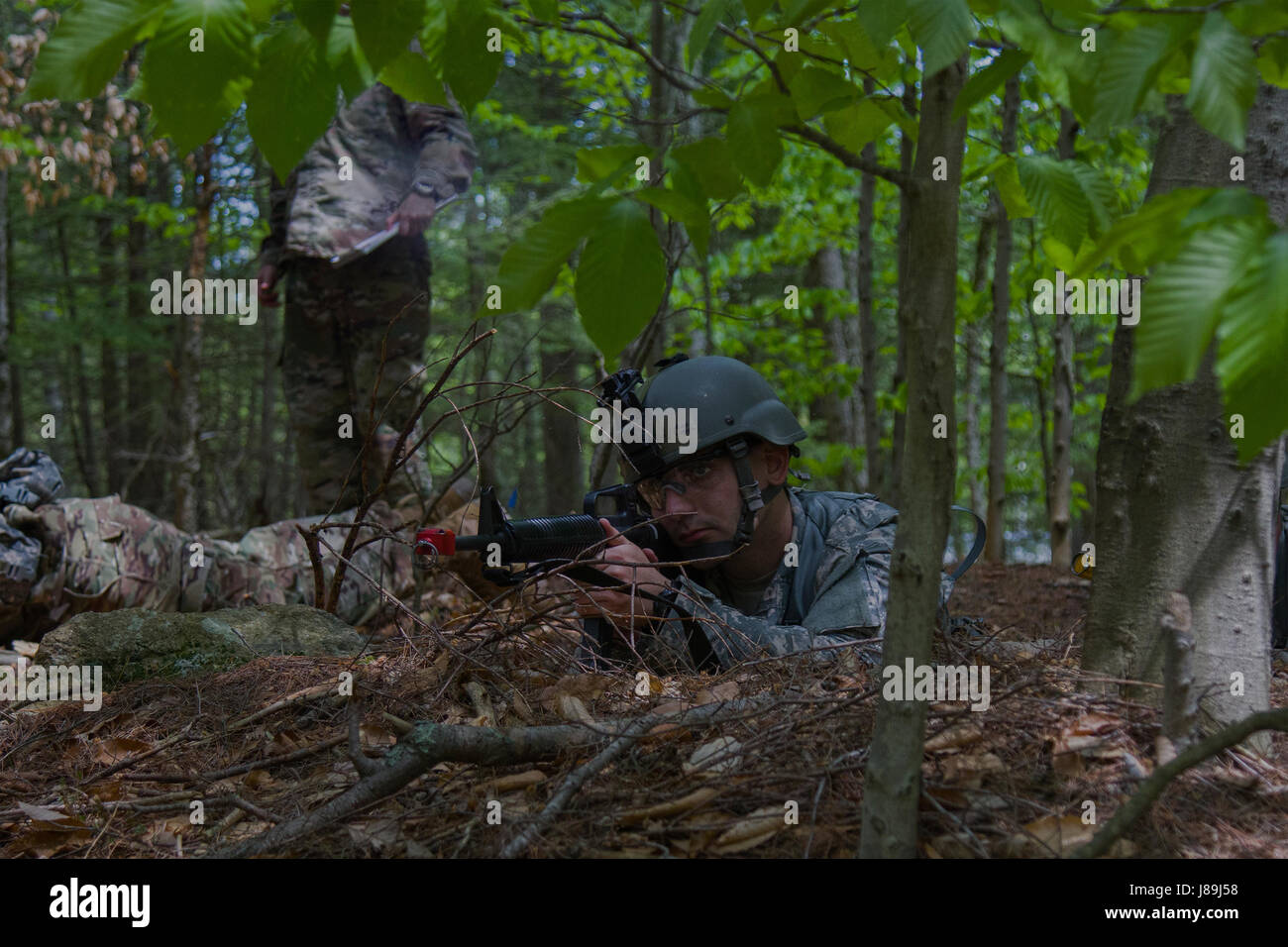 A U.S. Army officer candidate provides security during a reconnaissance operations lane at New Hampshire National Guard Training Site in Center Strafford, Nh., May 19, 2017. Soldiers from Connecticut, Maine, Massachusetts, New Hampshire, New Jersey, New York, Rhode Island, and Vermont participated in the Officer Candidate School Field Leadership Exercise in preparation for graduation and commission. (U.S. Army National Guard photo by Spc. Avery Cunningham) Stock Photo