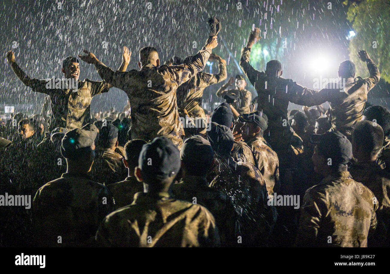 Iraqi special operations forces members spray water into the air and