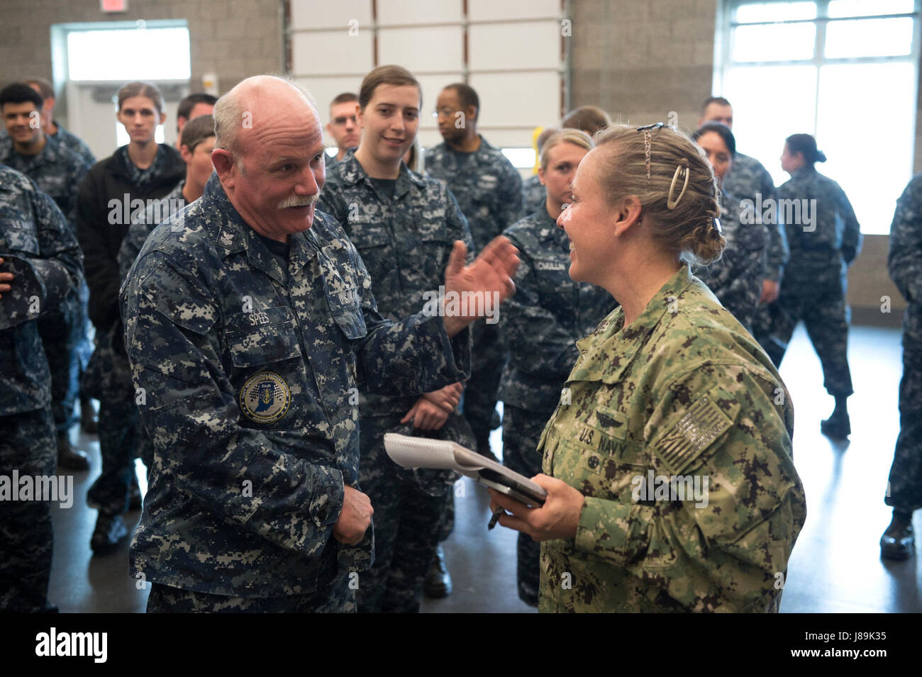 170520-N-QP351-087 INDIANAPOLIS (May 20, 2017) Rear Admiral Linda Wackerman, Deputy Commander, U.S. Naval Forces Southern Command, 4th Fleet, congratulates Culinary Spacialist 1st Class Thomas Spees, from Navy Operational Support Center Indianapolis, for over 38 years of service during an Admirals Call. Wackerman who also serves as the flag mentor for NOSC Indianapolis, held an all-hands Q&A session for E-6 and below Sailors to address upcoming changes and get feedback regarding Navy-related issues they feel need to be improved. (U.S. Navy photo by Mass Communication Specialist 2nd Class (SW/E Stock Photo