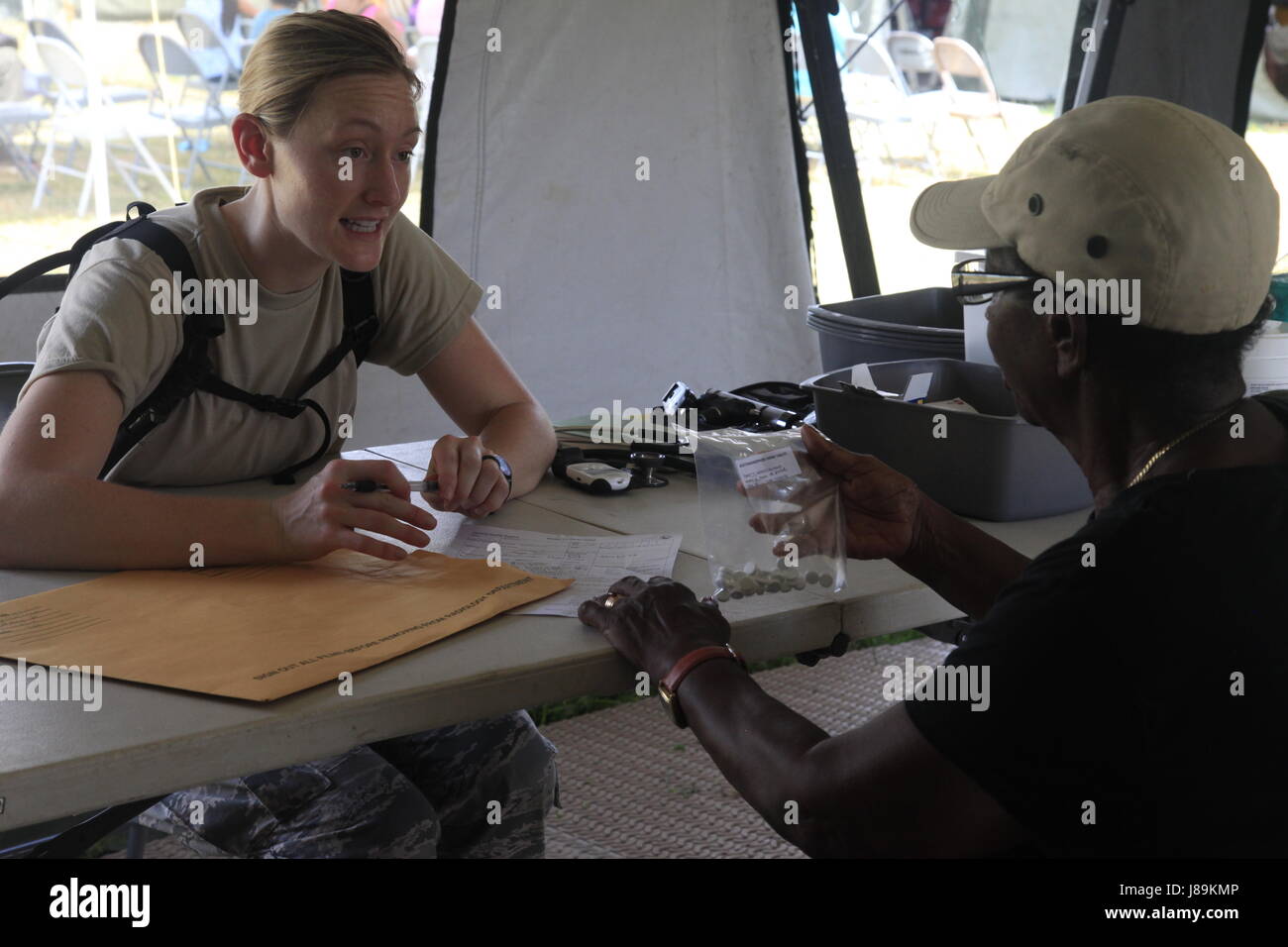 U.S. Air Force Capt. Glynnis Knobloch, with the 96th Medical Support Group from Eglin Air Force Base, Florida, prescribes medicine to a patient at a medical readiness event in Dangriga, Belize, May 22, 2017. This is the third and final medical event scheduled for Beyond the Horizon 2017, a U.S. Southern Command-sponsored, Army South-led exercise designed to provide humanitarian and engineering services to communities in need, demonstrating U.S. support for Belize. (U.S. Army photo by Spc. Kelson Brooks) (RELEASED) Stock Photo