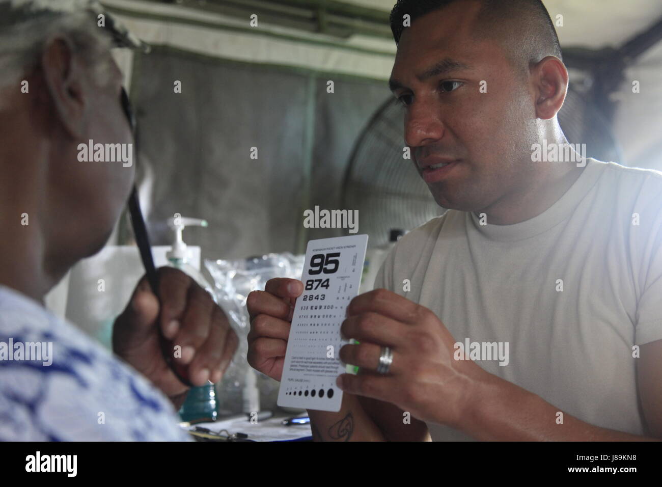 U.S. Air Force Tech Sgt. Benjamin Lemus, with the 96th Medical Support Group from Eglin Air Force Base, Florida, checks patient's vision at a medical readiness event in Dangriga, Belize, May 22, 2017. This is the third and final medical event scheduled for Beyond the Horizon 2017, a U.S. Southern Command-sponsored, Army South-led exercise designed to provide humanitarian and engineering services to communities in need, demonstrating U.S. support for Belize. (U.S. Army photo by Spc. Kelson Brooks) (RELEASED) Stock Photo