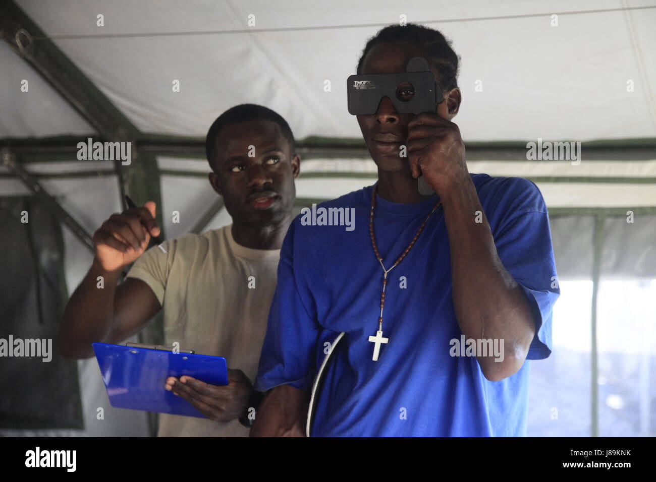 U.S. Air Force Staff Sgt. Kwesi Doamekpor, with the 96th Medical Support Group from Eglin Air Force Base, Florida, checks a patient's vision at a medical readiness event in Dangriga, Belize, May 22, 2017. This is the third medical event for Beyond the Horizon 2017, a U.S. Southern Command-sponsored, Army South-led exercise designed to provide humanitarian and engineering services to communities in need, demonstrating U.S. support for Belize. (U.S. Army photo by Spc. Kelson Brooks) (RELEASED) Stock Photo