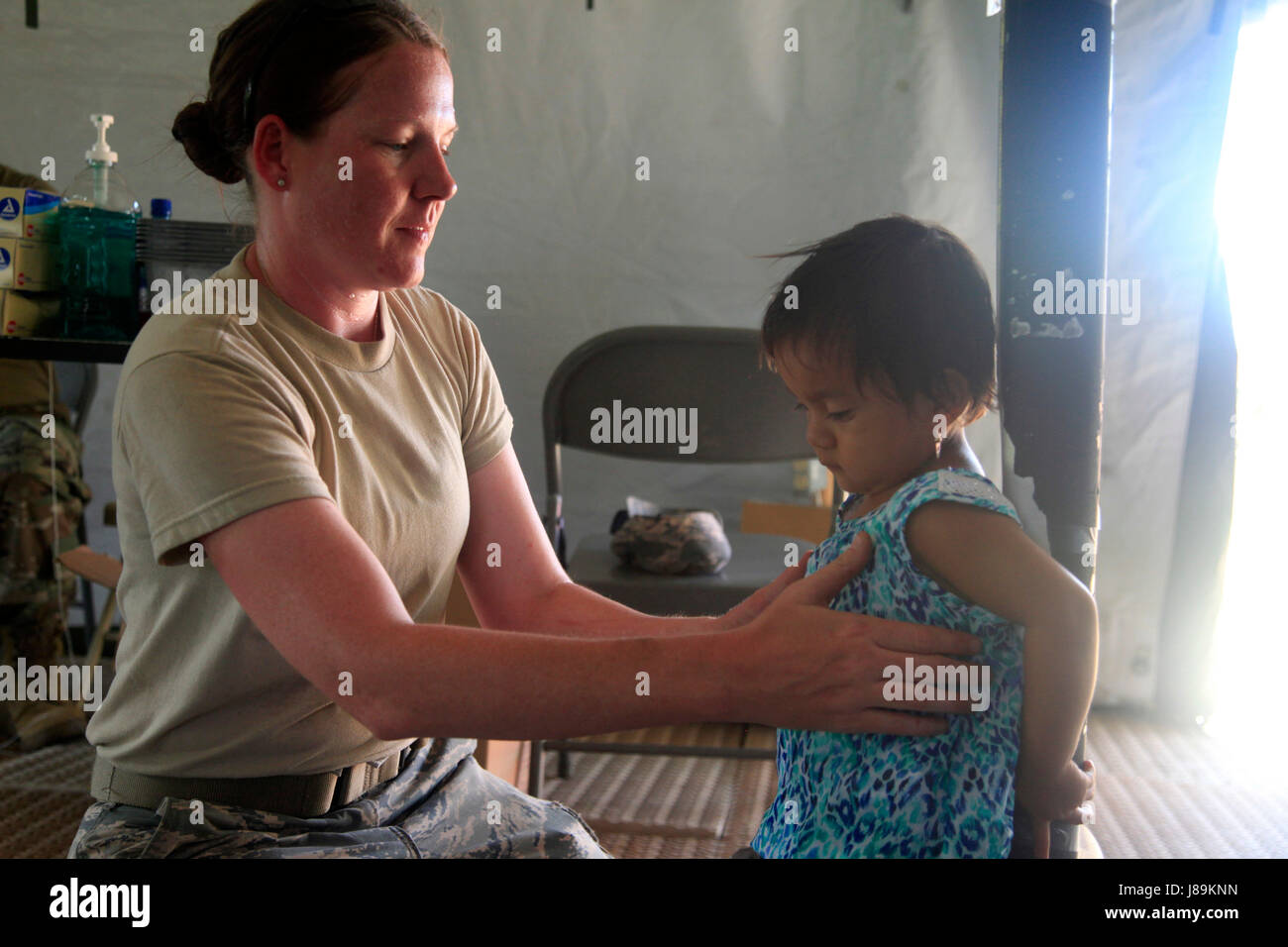 U.S. Air Force Master Sgt. Laura Winn, with the 96th Medical Support Group from Eglin Air Force Base, Florida, measures a patient's height, at a medical readiness event in Dangriga, Belize, May 22, 2017. This is the third medical and final event scheduled for Beyond the Horizon 2017, a U.S. Southern Command-sponsored, Army South-led exercise designed to provide humanitarian and engineering services to communities in need, demonstrating U.S. support for Belize. (U.S. Army photo by Spc. Kelson Brooks) (RELEASED) Stock Photo