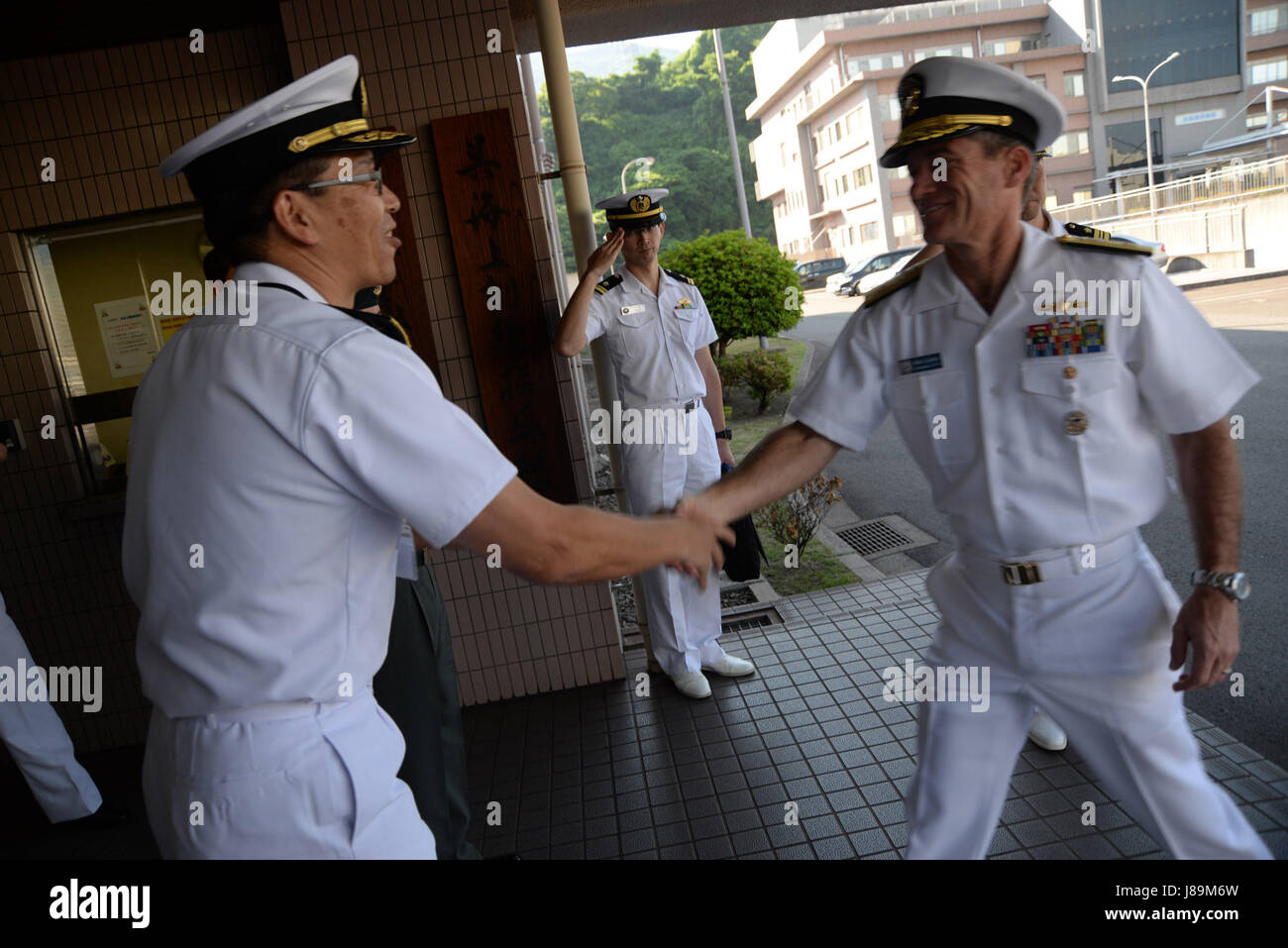 170522-N-GY309-016 KURE, Japan (June 22, 2017) – Rear Adm. Marc Dalton, commander, Amphibious Force 7th Fleet, greets Japan Maritime Self Defense Rear Adm. Hideki Yuasa, Mine Warfare Force Commander at the start of U.S.-Japan bilateral amphibious and mine warfare staff talks. The talks are being held to increase mutual understanding and lay out engagement opportunities in amphibious operations and mine warfare in order to increase combat readiness of both U.S. and Japan Self Defense forces. (U.S. Navy Photo by Lt. Adam Cole/Released) Stock Photo