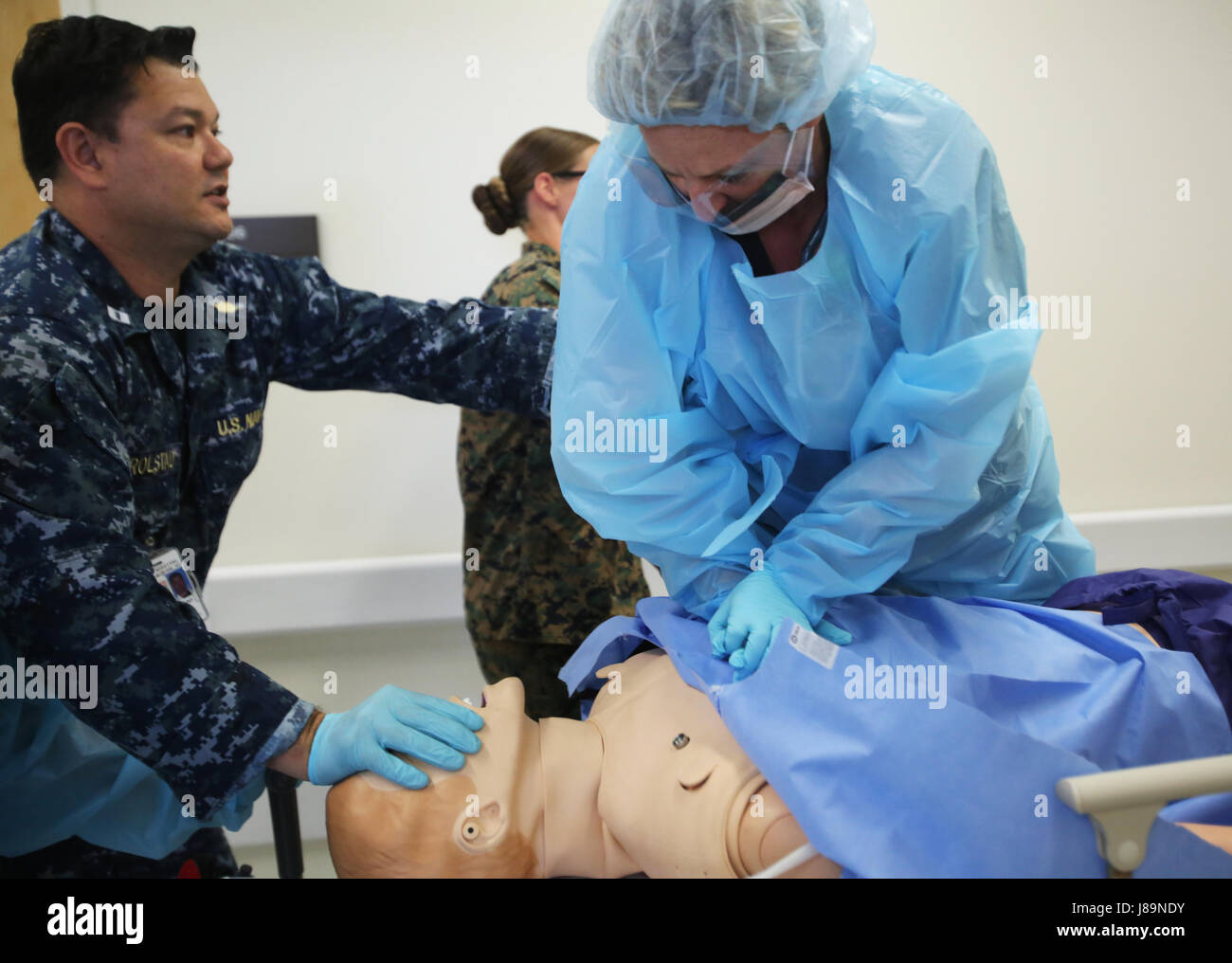 Naval Hospital Camp Lejeune’s emergency medical staff practices admitting a patient, using a manikin, into NHCL during an enroute care sustainment training at Camp Lejeune, N.C., May 24, 2017. The training was conducted to simulate a combat casualty evacuation in order to test the hospital’s trauma readiness and their ability to evacuate casualties under combat conditions. The NHCL’s emergency medical staff teamed with 2nd Medical Battalion, 2nd Marine Logistics Group’s medical staff and Marine Medium Tilt Rotor Squadron VMM 264. (U.S. Marine Corps photo by Lance Cpl. Raul Torres) Stock Photo