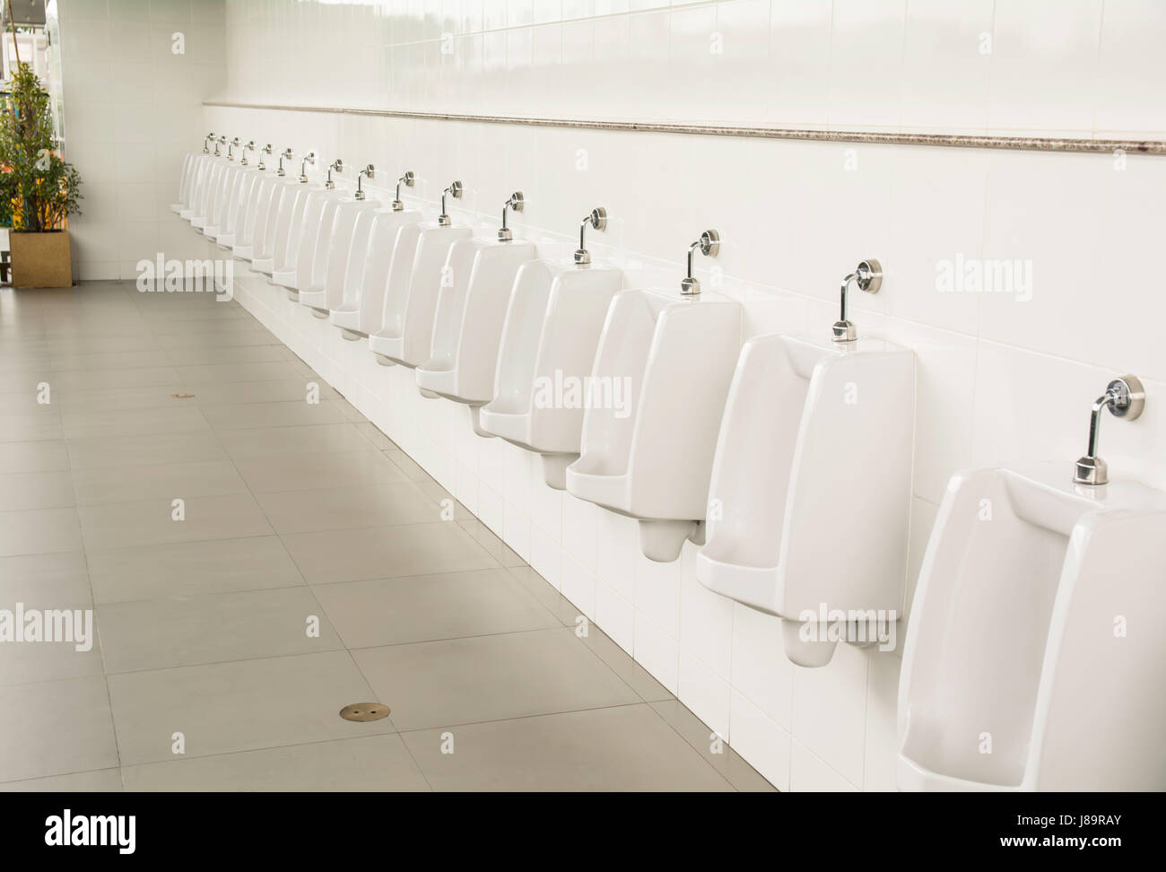 public empty restroom for washing hands sinks and mirrors Stock Photo