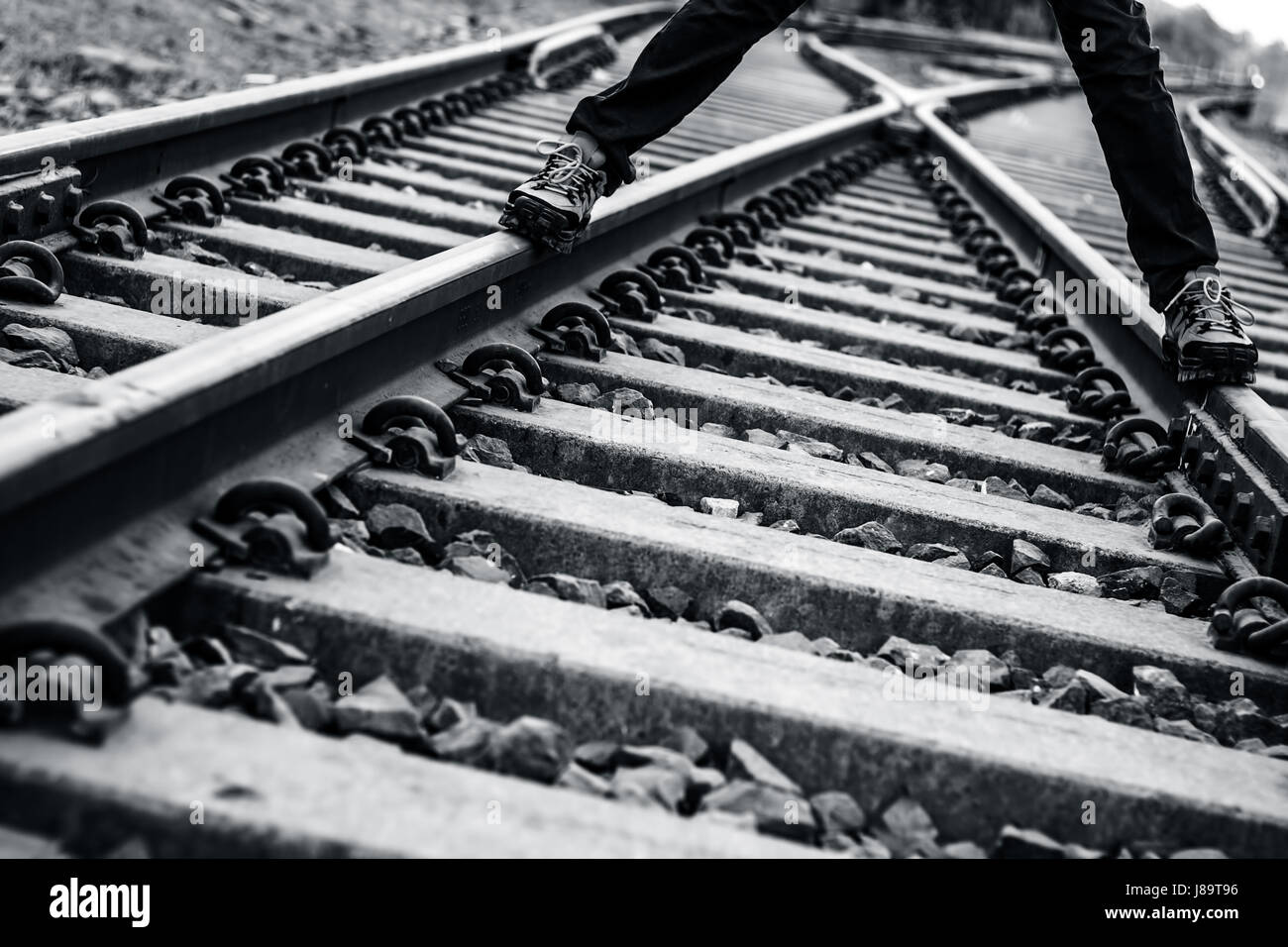 A boy standing on railway tracks wearing leather shoes Stock Photo - Alamy