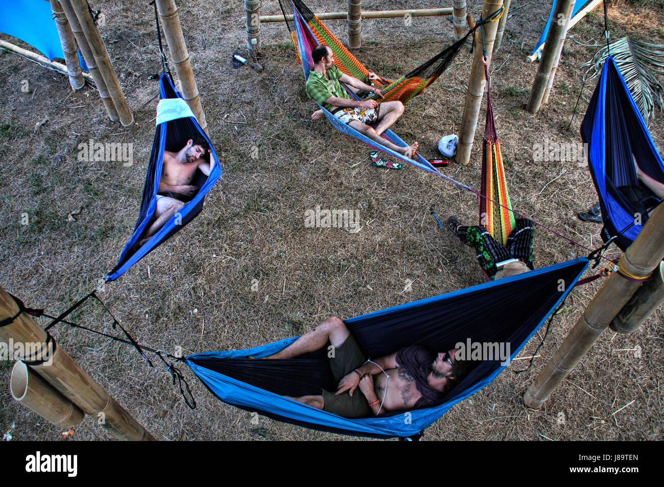 Tired Envision attendants nap in hammocks hung from a bamboo tower at the 2014 Envision Festival. Stock Photo