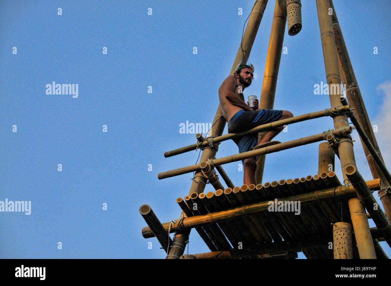 A man stands on a bamboo platform at the 2014 Envision Festival in Costa Rica. Stock Photo
