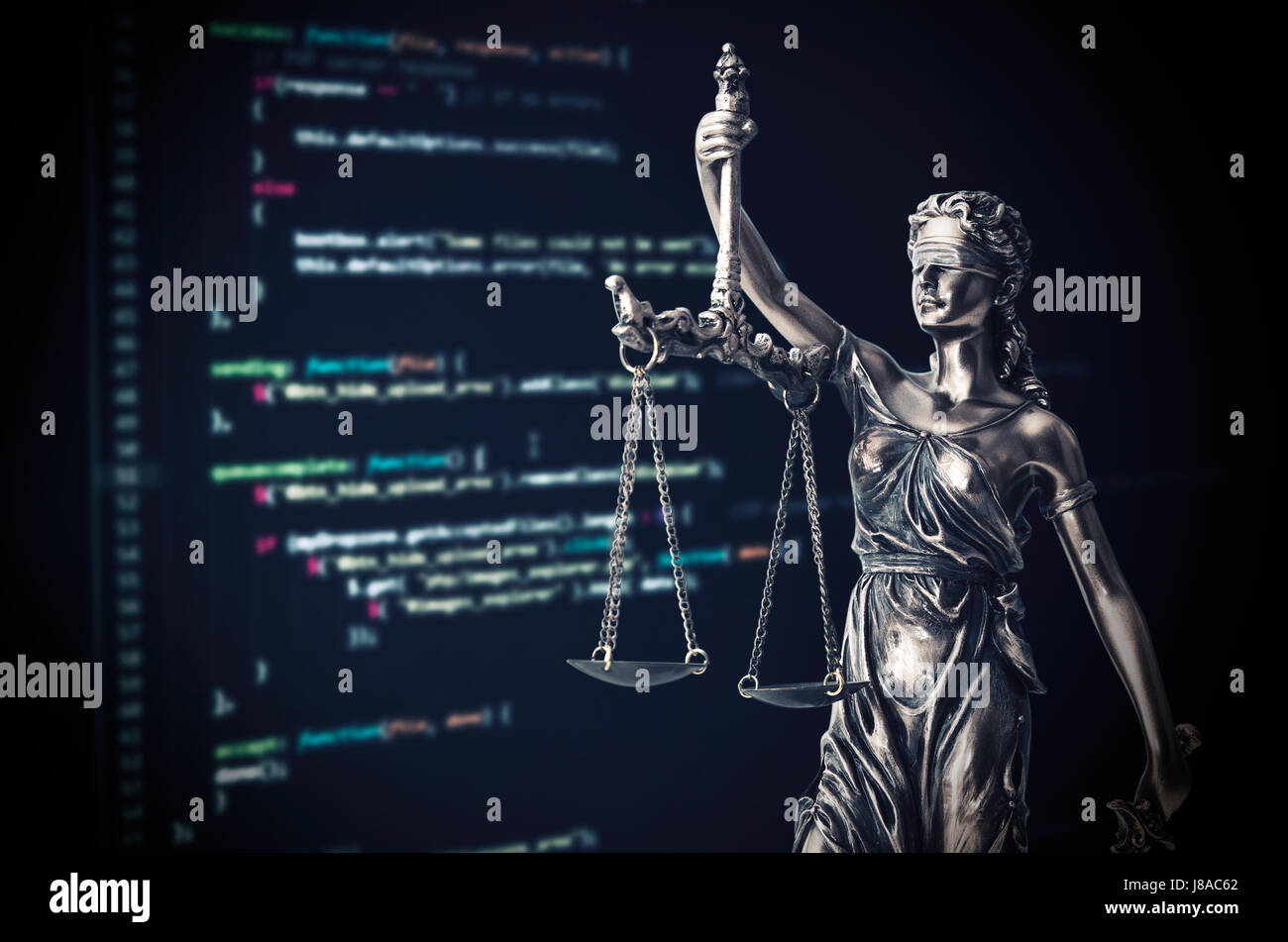 Justice statue with code on monitor device in background. programming code law crime justice internet statue themis concept Stock Photo