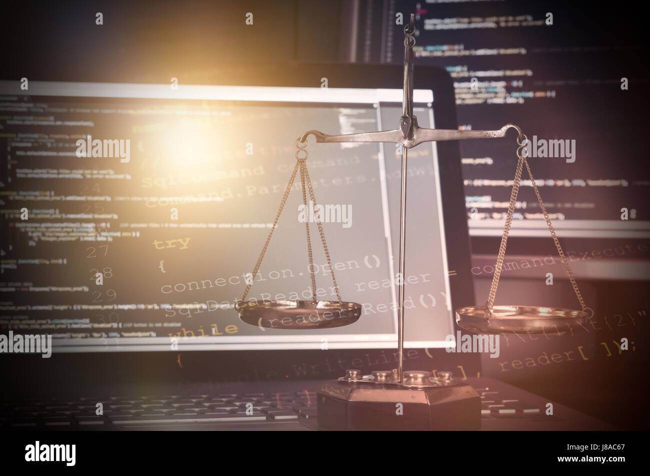 Justice weight scales with code on monitor in background. programming code law weight scale crime justice internet concept Stock Photo