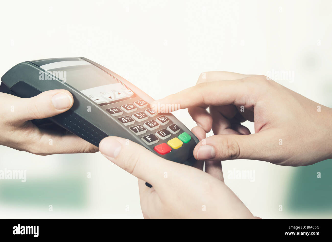 Hand with credit card swipe through terminal for sale in shop Stock