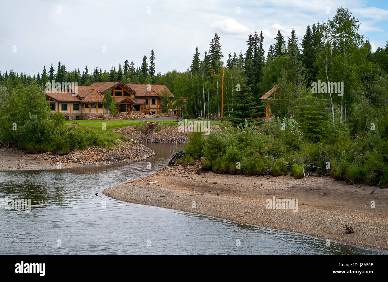 Log Home along the river in Alaska near Fairbanks Stock Photo