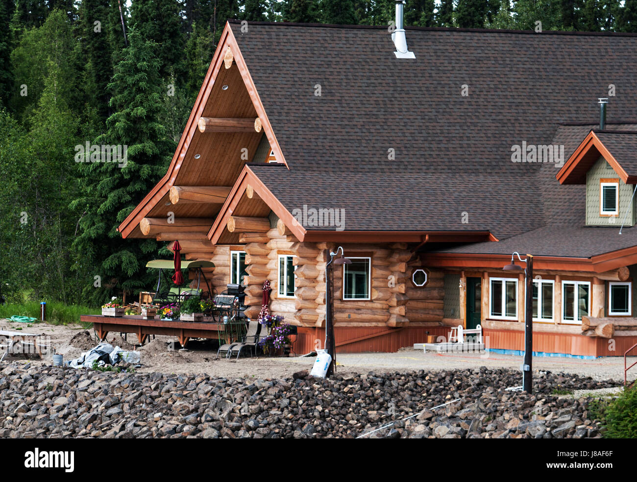 Log Home on a river shore in Alaska Stock Photo