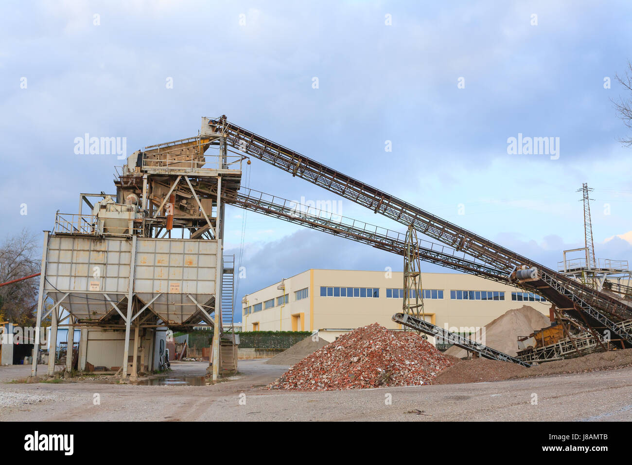 Stone quarry with silos and conveyor belts. Industrial equipment. Mining Stock Photo