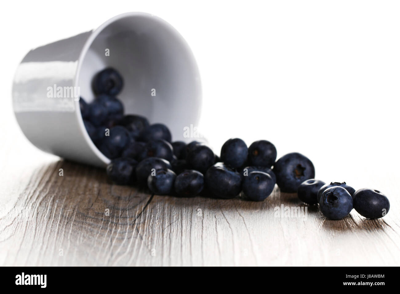 roll blueberries from upset cup Stock Photo Alamy