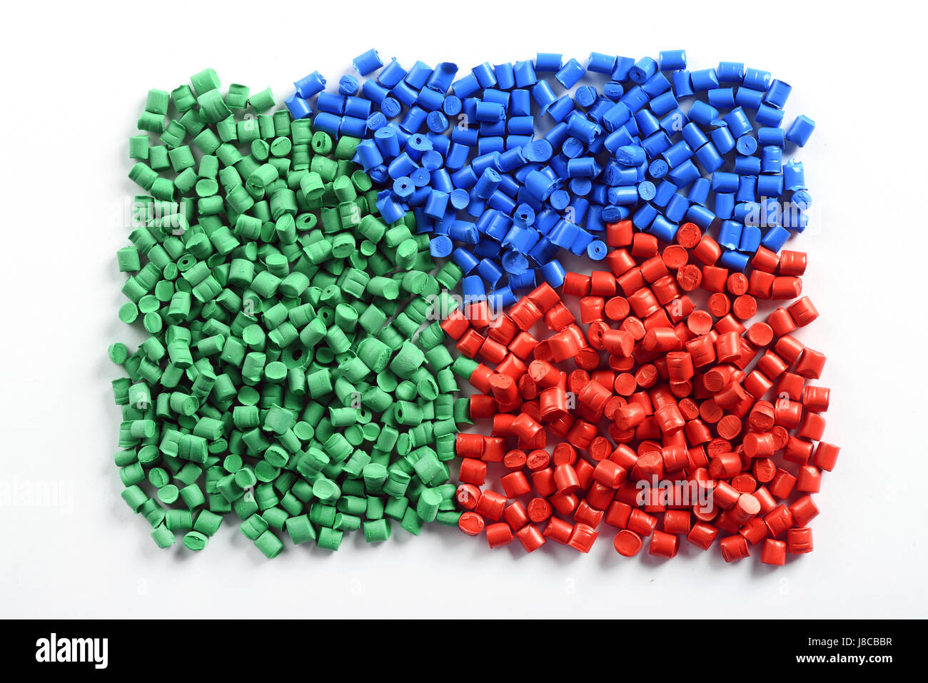 Colorful collection of molded plastic pellets or granules made from recycled waste to be reused in the industry as a raw material to manufacture produ Stock Photo