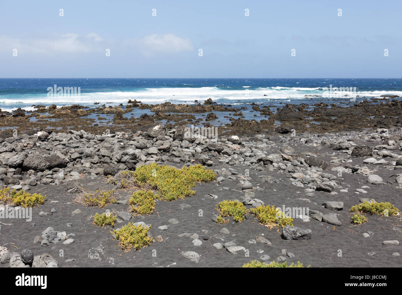 Lanzarote coast - old lava flows extend to the sea, west coast, Lanzarote, Canary Islands Europe Stock Photo
