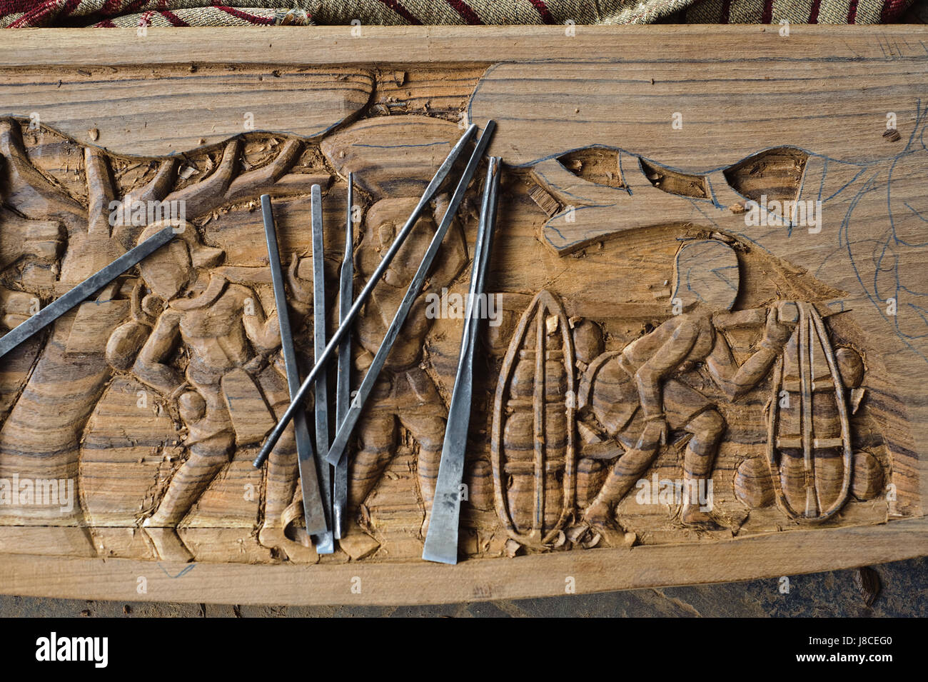 Ornate details on a wood table ( India) It is representing tribal musicians. Stock Photo