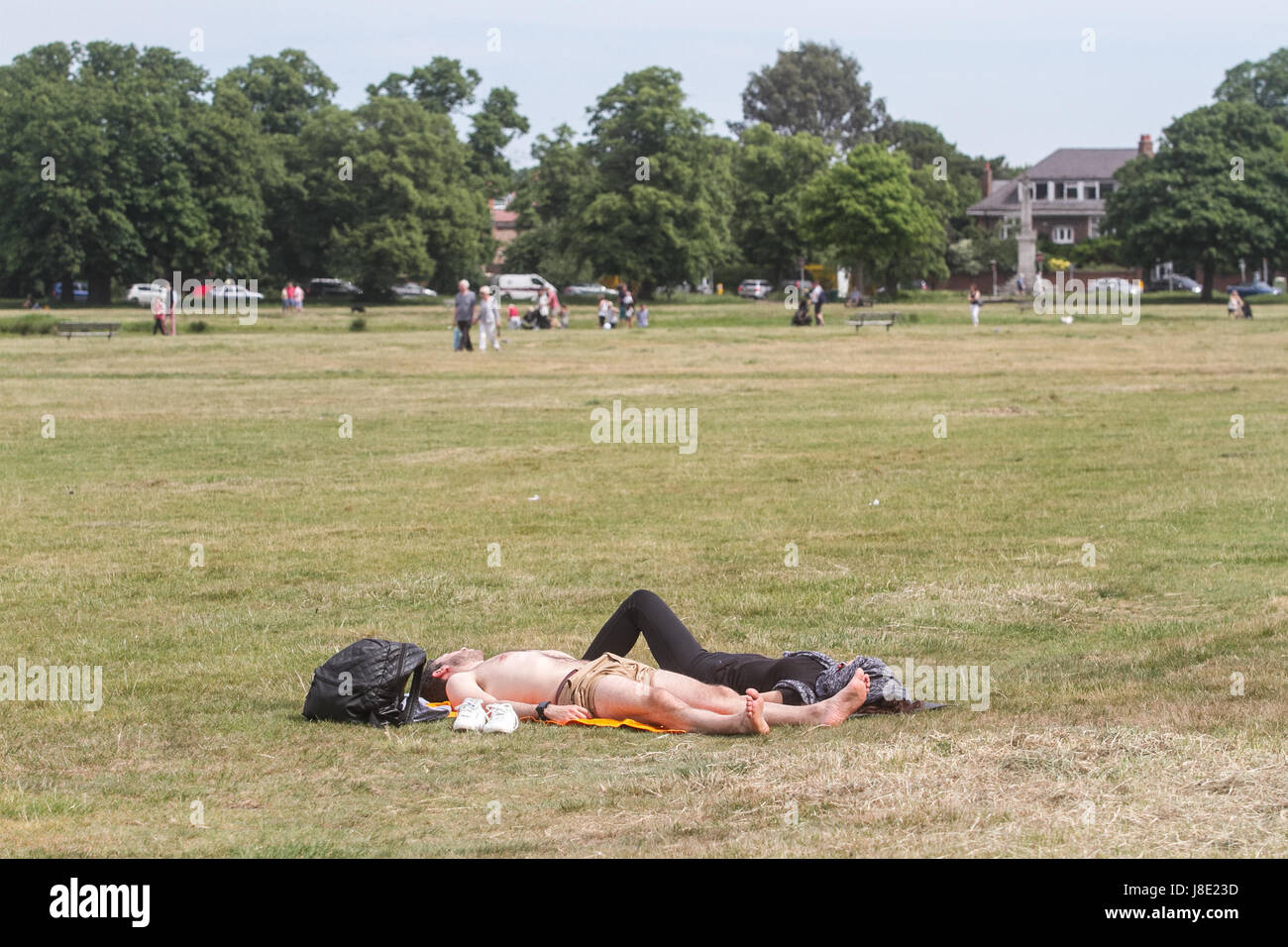 London, UK. 28th May, 2017. UK Weather. People sunbathing on Wimbledon