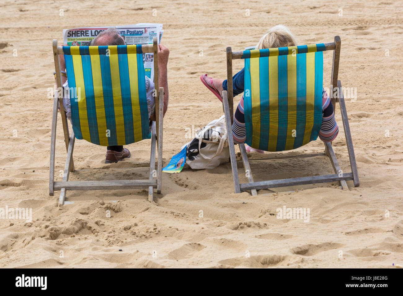 Bournemouth, Dorset, UK. 28th May, 2017. UK weather: overcast day at Bournemouth beaches, but the sun is trying to break through. Visitors head to the seaside to make the most of the Bank Holiday weekend. Couple in deckchairs on Bournemouth beach. Credit: Carolyn Jenkins/Alamy Live News Stock Photo
