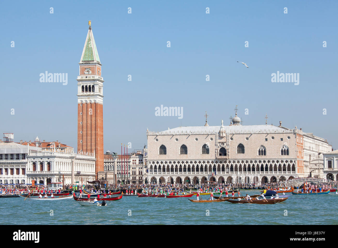 Venice, Veneto, Italy. 28th May, 2017. Participants in the Fete de la Sensa Venice, Veneto Italy with rowing teams in their boats in front of the Doges Palace and Campanile accompanying the Serrenisimo historial boat carrying the dignatories to Lido for the blessing of the gold ring which is then tossed into the lagoon marrying Venice to the sea. Stock Photo