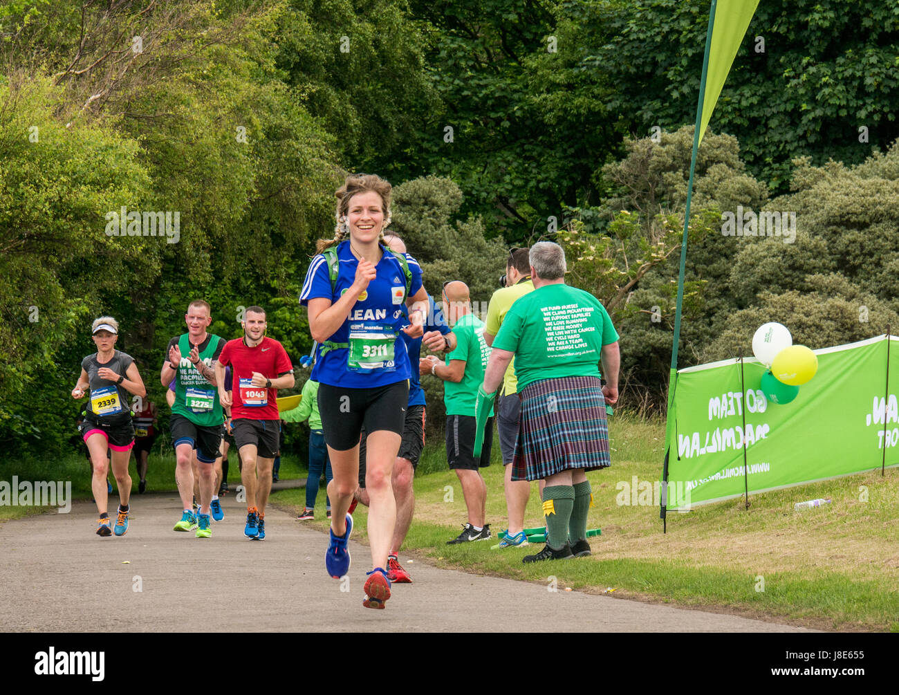 Gosford Estate, East Lothian, Scotland, UK. 28th May, 2017. A smiling female runner with blonde pigtails at Edinburgh Marathon Festival 2017 in Gosford Estate at Mile 18 Stock Photo