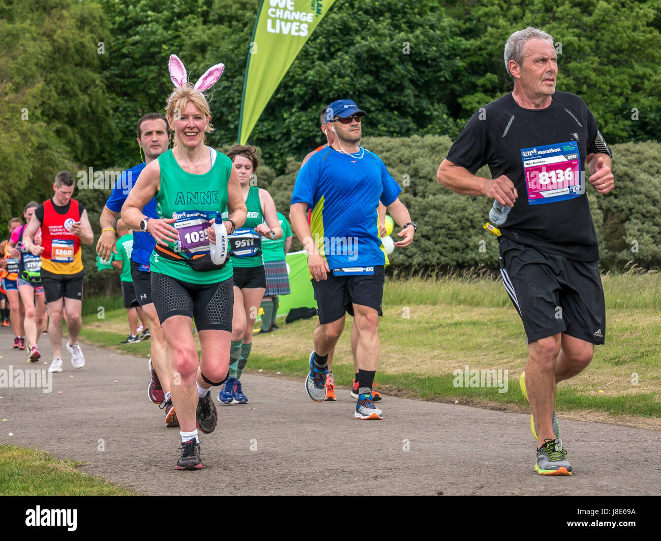Gosford Estate, East Lothian, Scotland, UK. 28th May, 2017. A  smiling female runner with bunny ears in the Edinburgh Marathon Festival 2017 in Gosford Estate at Mile 18 Stock Photo