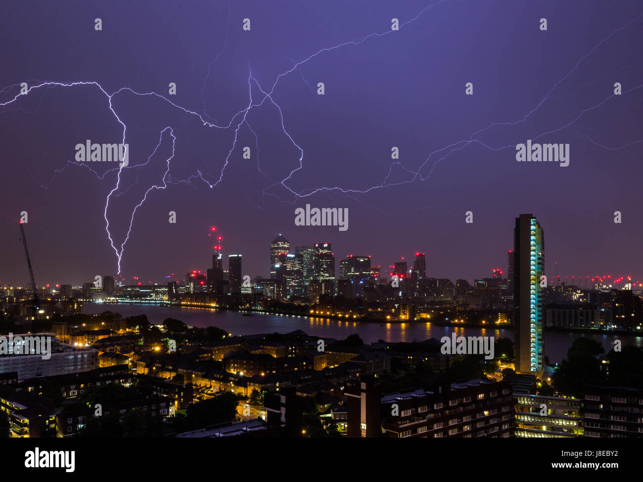 London, UK. 29th May, 2017. UK Weather: Lightning strikes over Canary Wharf business park buildings and River Thames © Guy Corbishley/Alamy Live News Stock Photo
