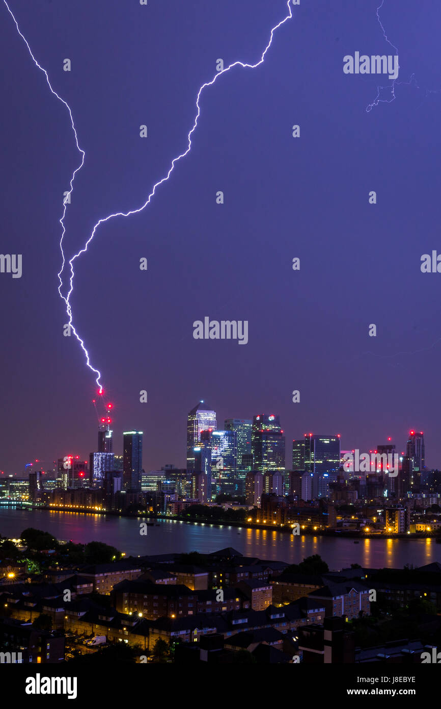 London, UK. 29th May, 2017. UK Weather: Lightning strikes over Canary Wharf business park buildings and River Thames © Guy Corbishley/Alamy Live News Stock Photo