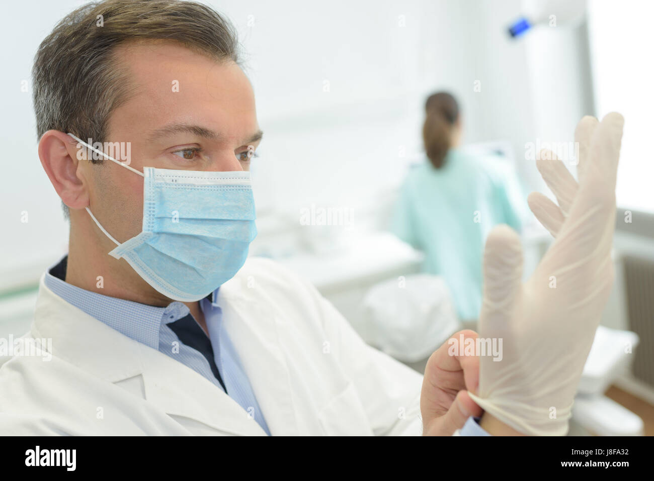 putting disposable gloves on Stock Photo Alamy