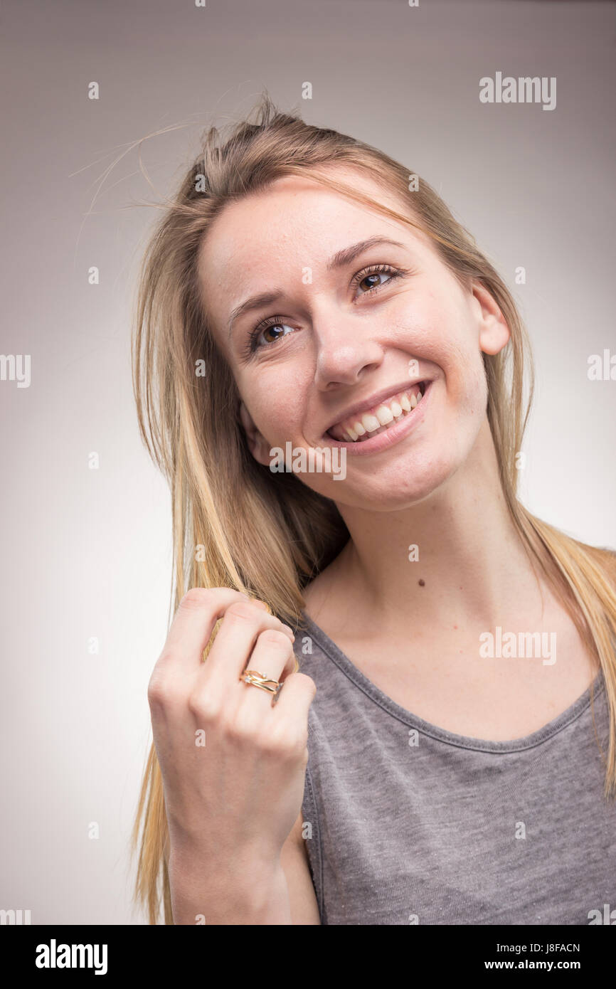 candid portrait, one young adult woman only, studio background, casual