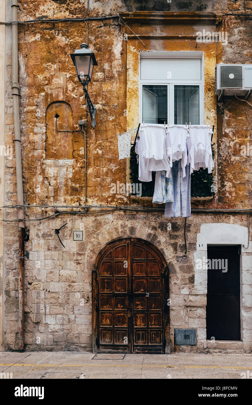 Laundry hung to dry from a house in Bari Vecchia, Puglia, Italy Stock Photo